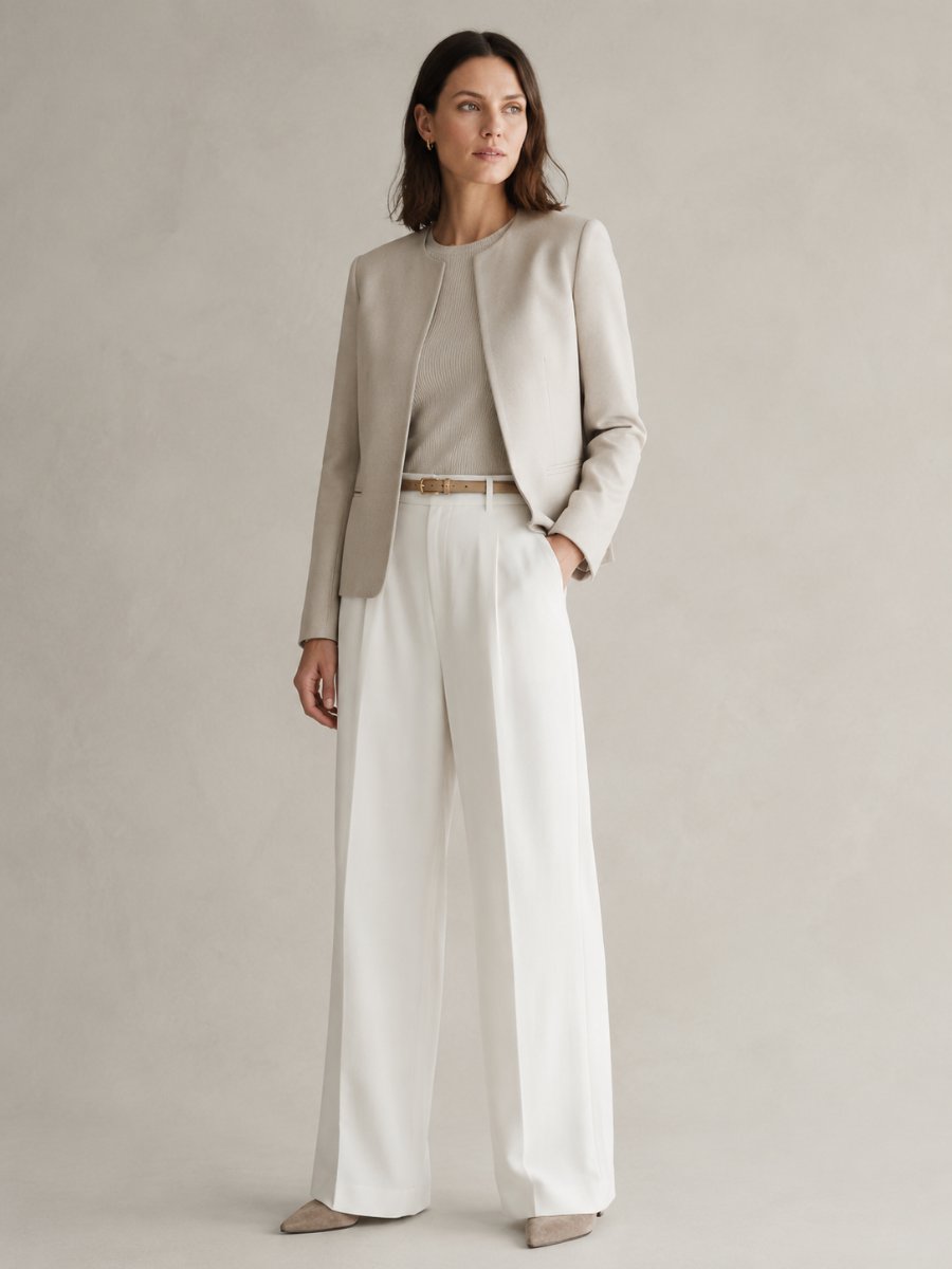 Woman in a head-to-toe monochrome collarless blazer outfit