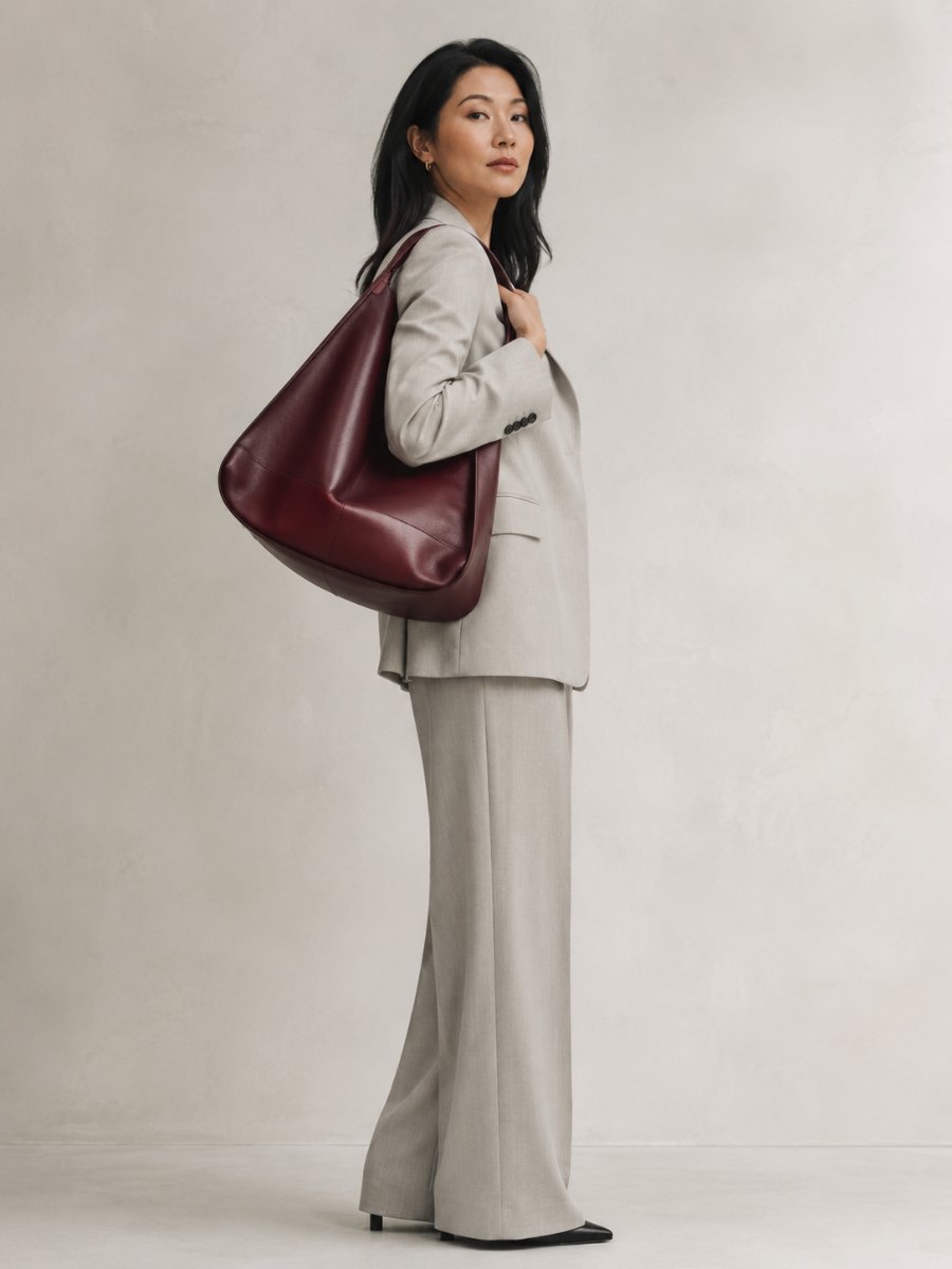 Woman carrying an oversized sculptural statement bag