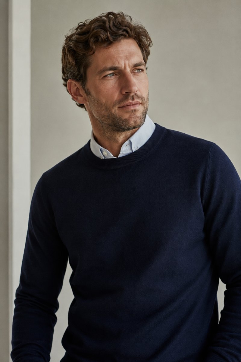 Man wearing a fine merino crewneck over a collared shirt