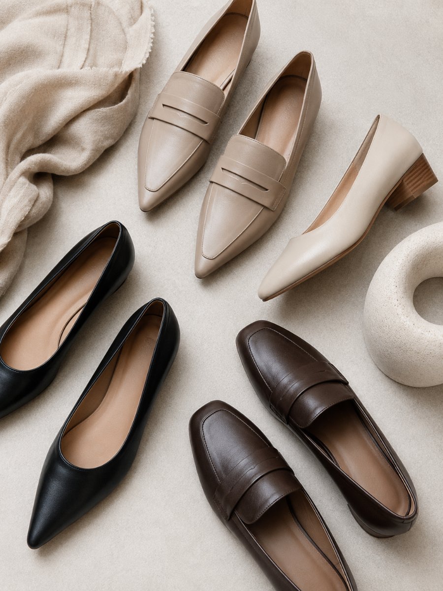 Flat lay of polished flats, loafers and a low block heel
