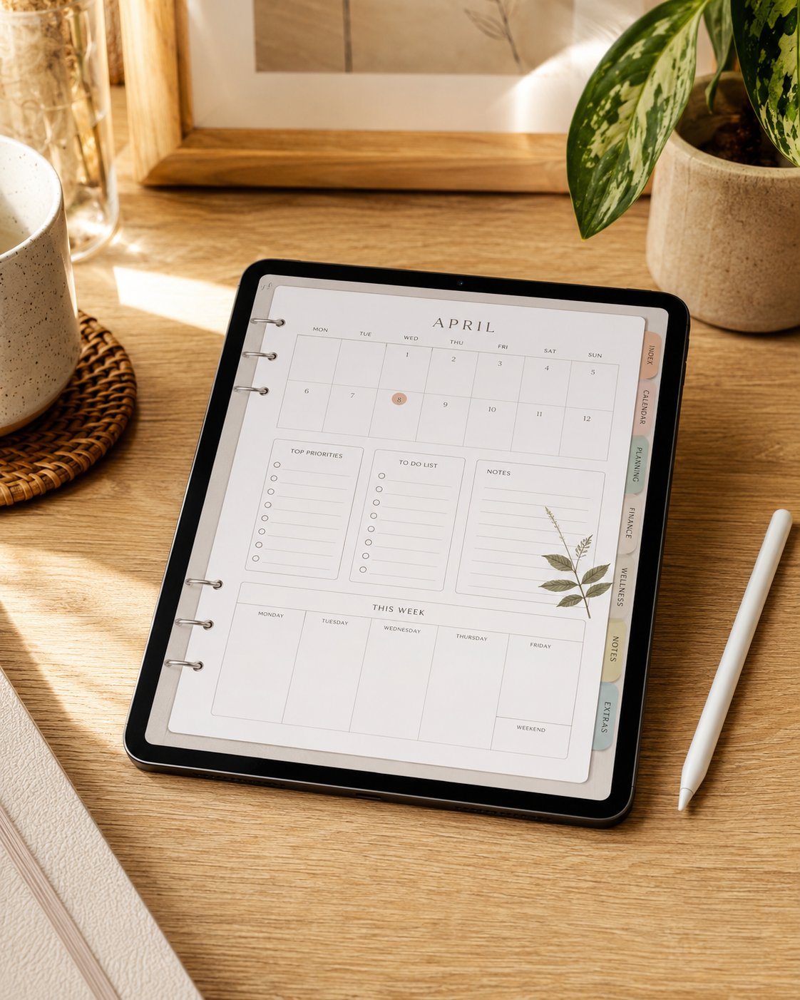Tablet with a stylus displaying a digital planner with tabs