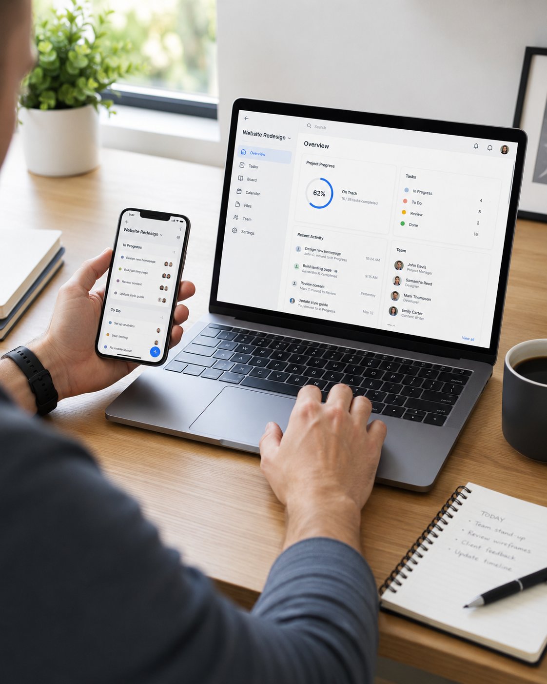 Person managing tasks on both phone and laptop with synced project apps